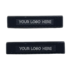 Two black rectangular bands from the Pedal Grip Set - 3/8", each featuring the text "YOUR LOGO HERE" printed in white on the front.