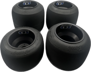 A Burris 4-Tire Set - Black Wheels - 11 Compound is displayed in a square formation on a plain background, showcasing the brand name "Burris" prominently on each sidewall.