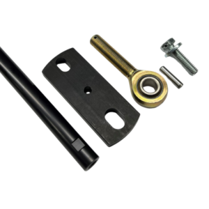 The "Spacer Kit for Right Side Caster L Block" includes various machine parts such as a black cylindrical rod, a threaded eye bolt, a metallic mounting plate, a screw, and a pin, all arranged on a white background.