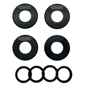 A Front Wheel Hub Bearing Shield Set - 5/8" displayed on a white background, showcasing various sizes of black metal and rubber gaskets in two rows. The top row features larger metal gaskets, and the bottom row includes smaller rubber gaskets.