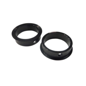 Two black circular metal rings, each featuring a small hole on their side, displayed on a white background. These are from the Rear Bearing Shield Set - 1.590 Race OD designed to fit FYH Small Bearings.