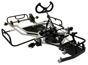 A bare-bones go-kart chassis with a steering wheel, steering column, and brake system components, without an engine or wheels, displayed on a white background.