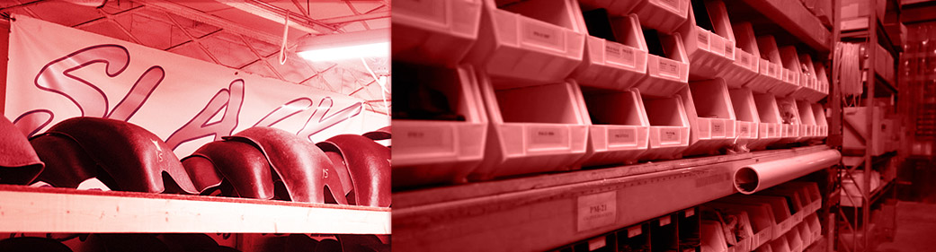 Shelves filled with various automotive parts in an organized manner, with a banner hanging from the ceiling in the background.