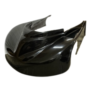 A black motorcycle fairing with aerodynamic curves and a glossy finish. One side appears to be damaged or broken.